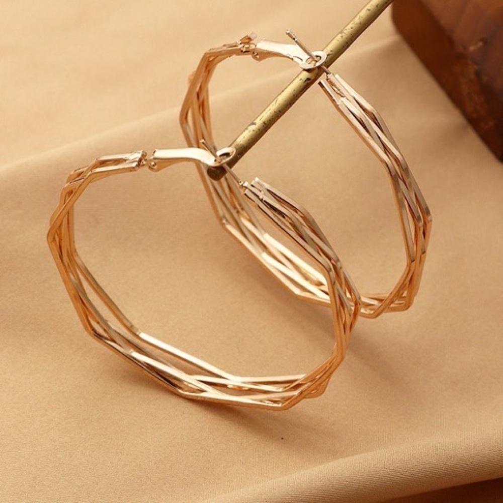 Gold plated twisted large hoop earrings.